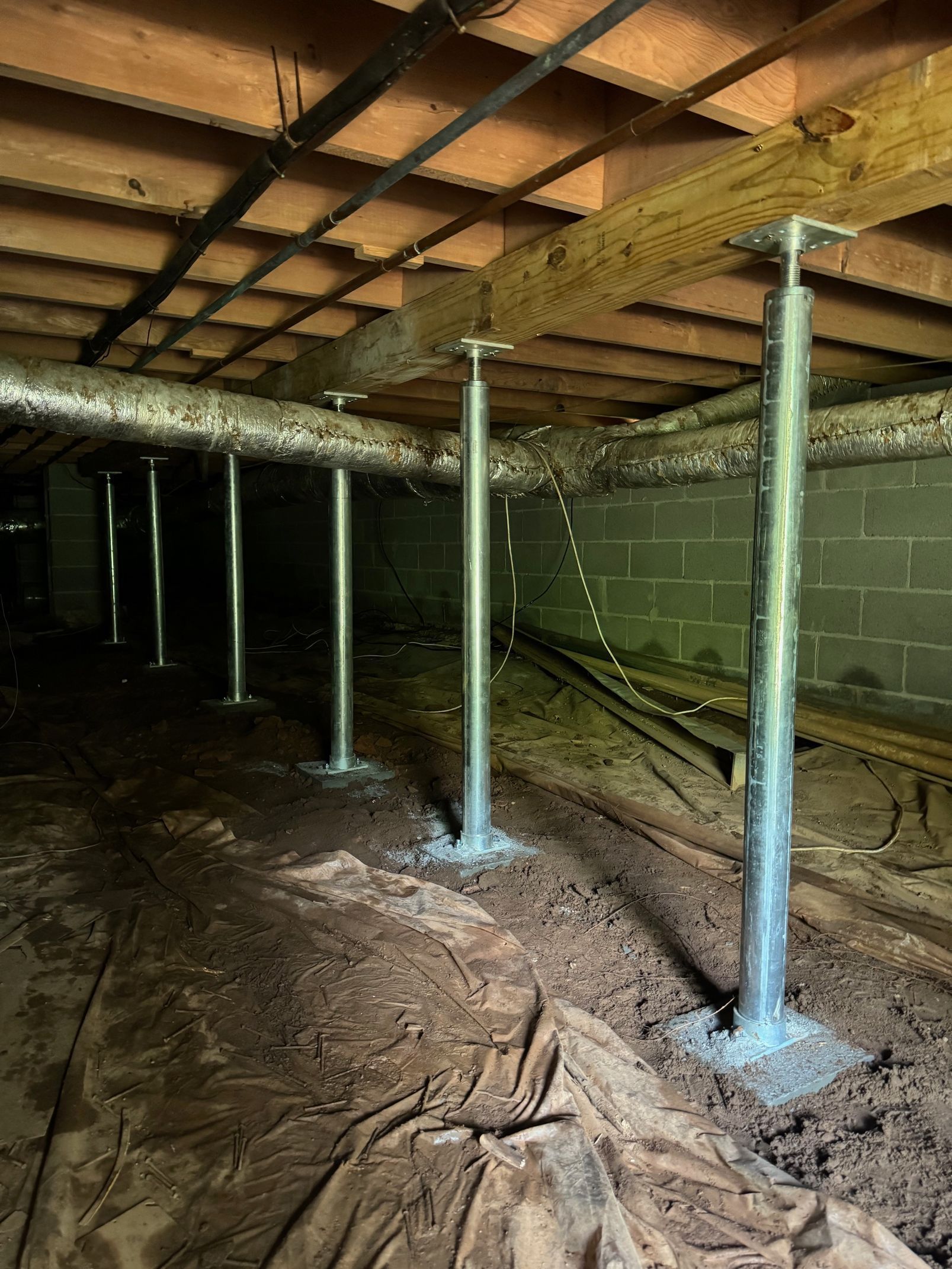 A basement with a lot of pipes coming out of it.