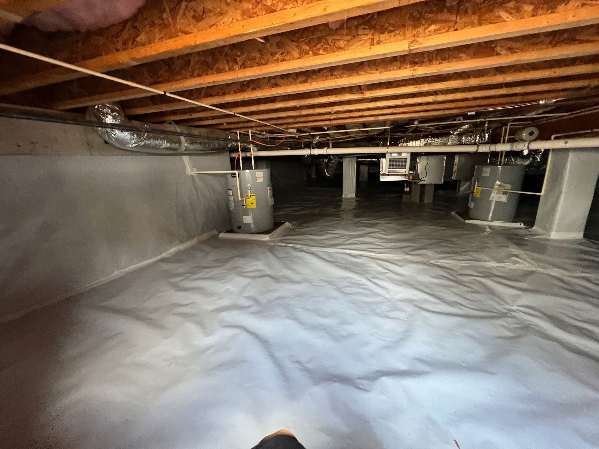A basement filled with water heaters and insulation.