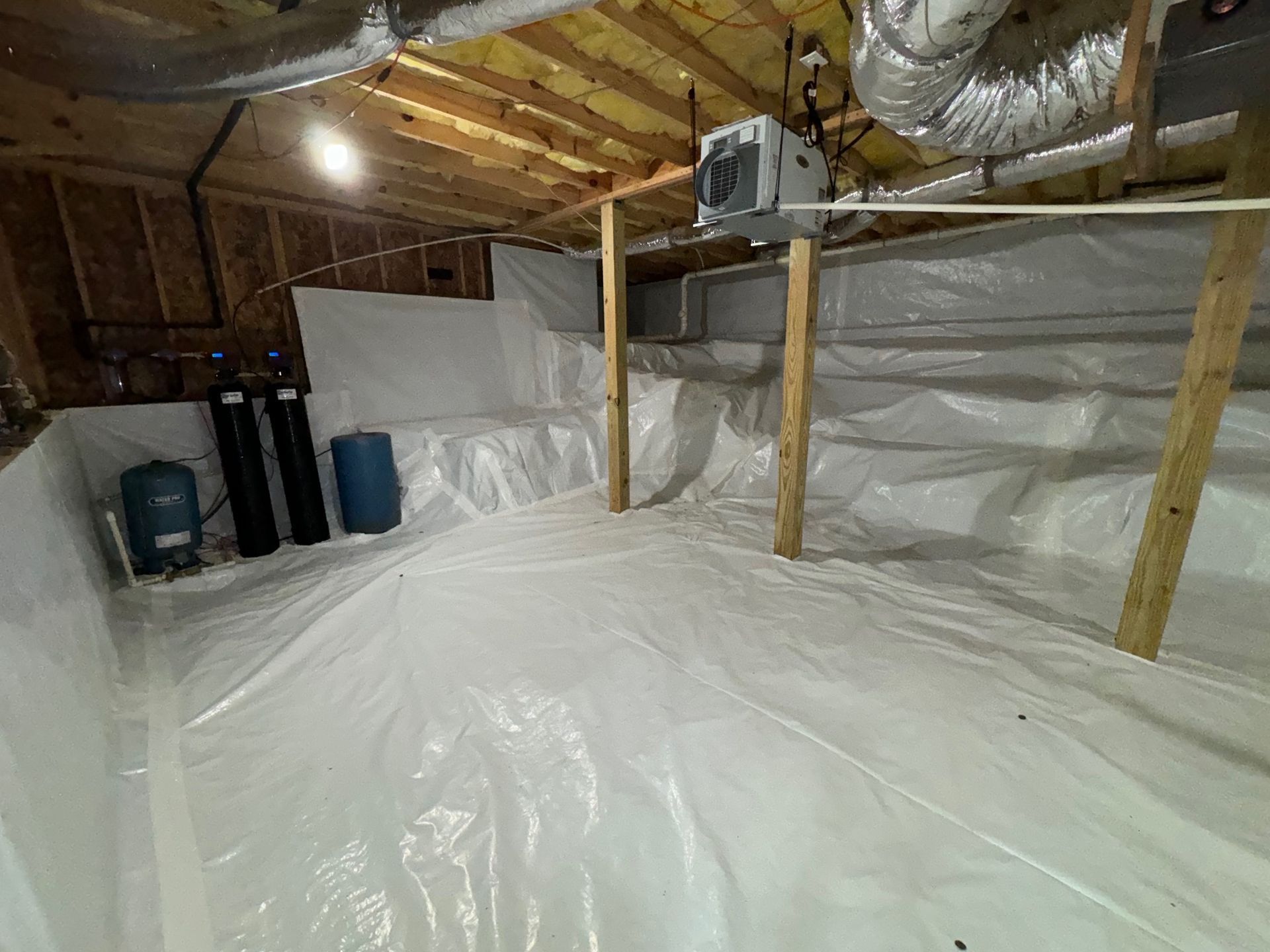 A basement with a lot of plastic covering it.