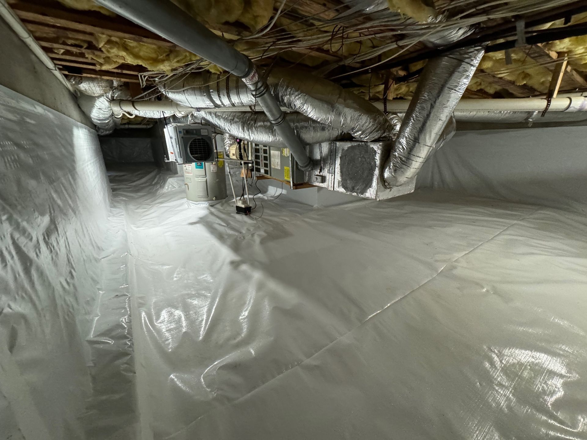 A basement with a lot of plastic covering it.