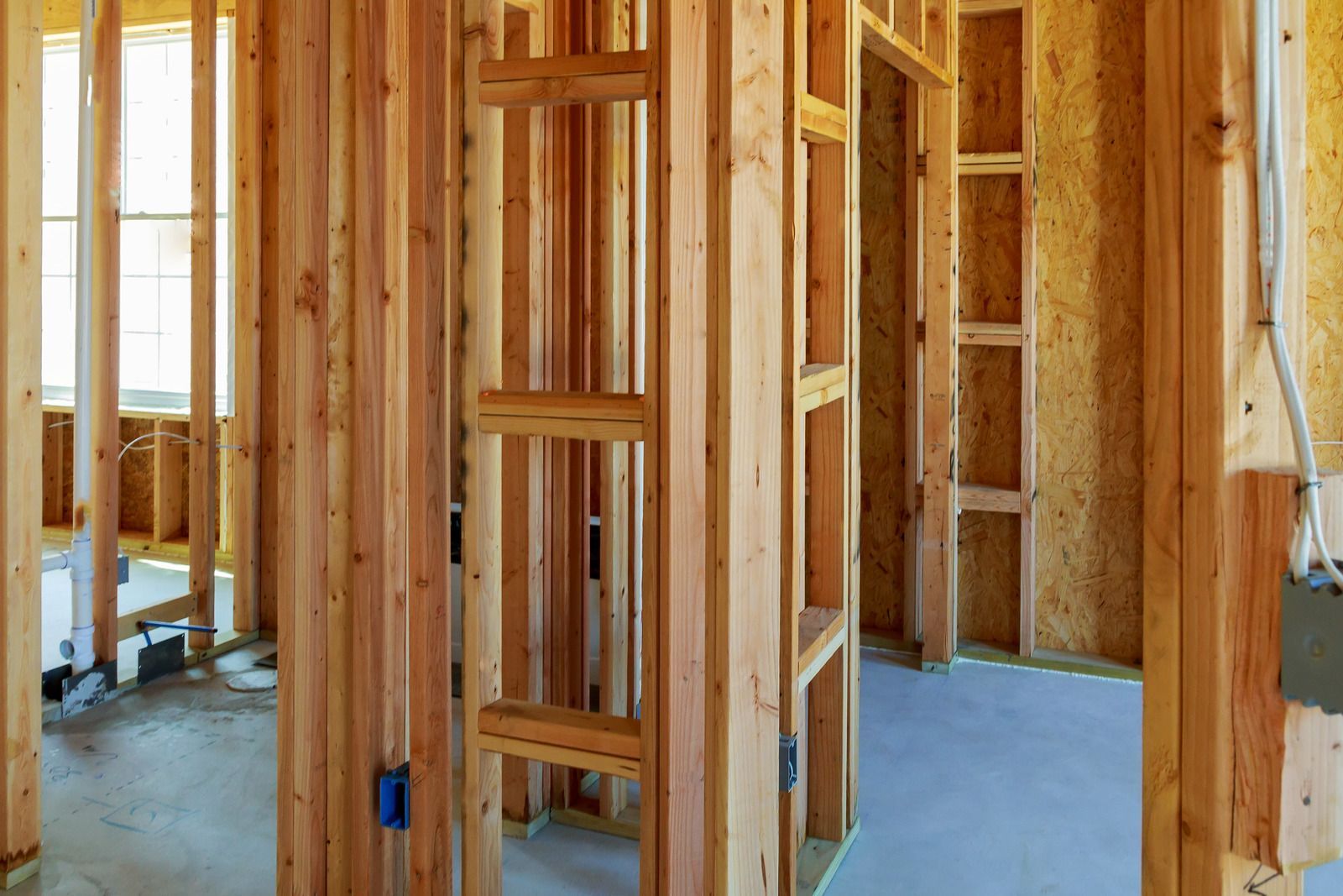 Interior of a building under construction, wooden framing, open walls.