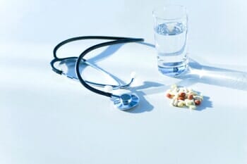 Stethoscope, Glass of Water and Pills — Medical Center in Stafford, VA