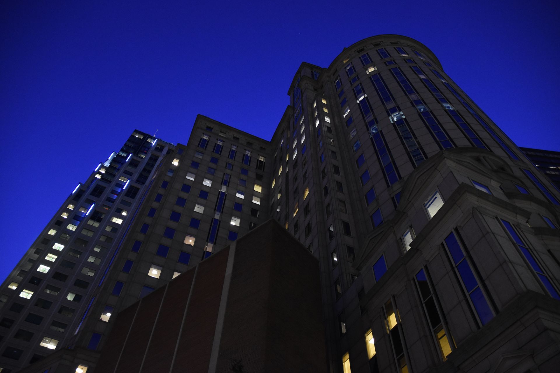 Looking up at a tall building at night