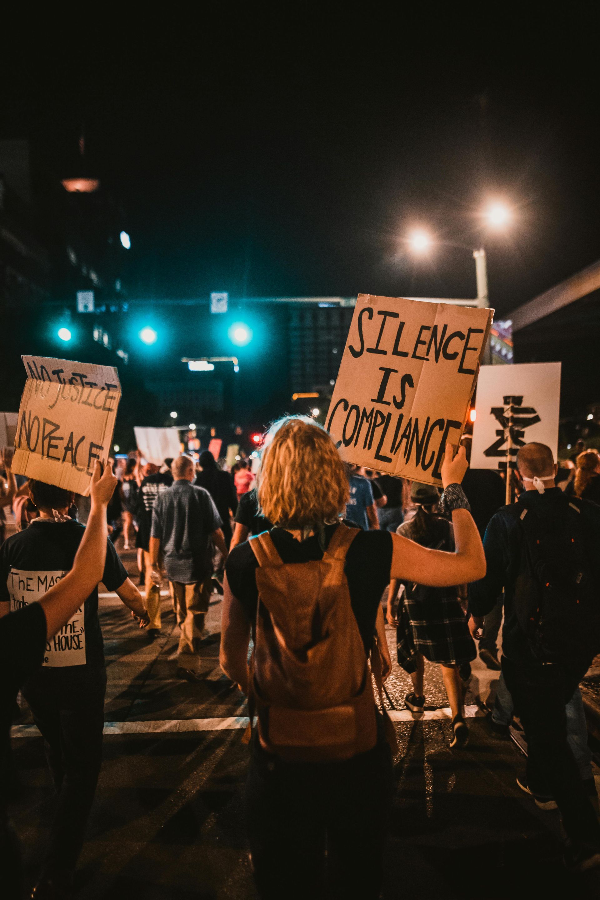 A group of people are holding signs at a protest.