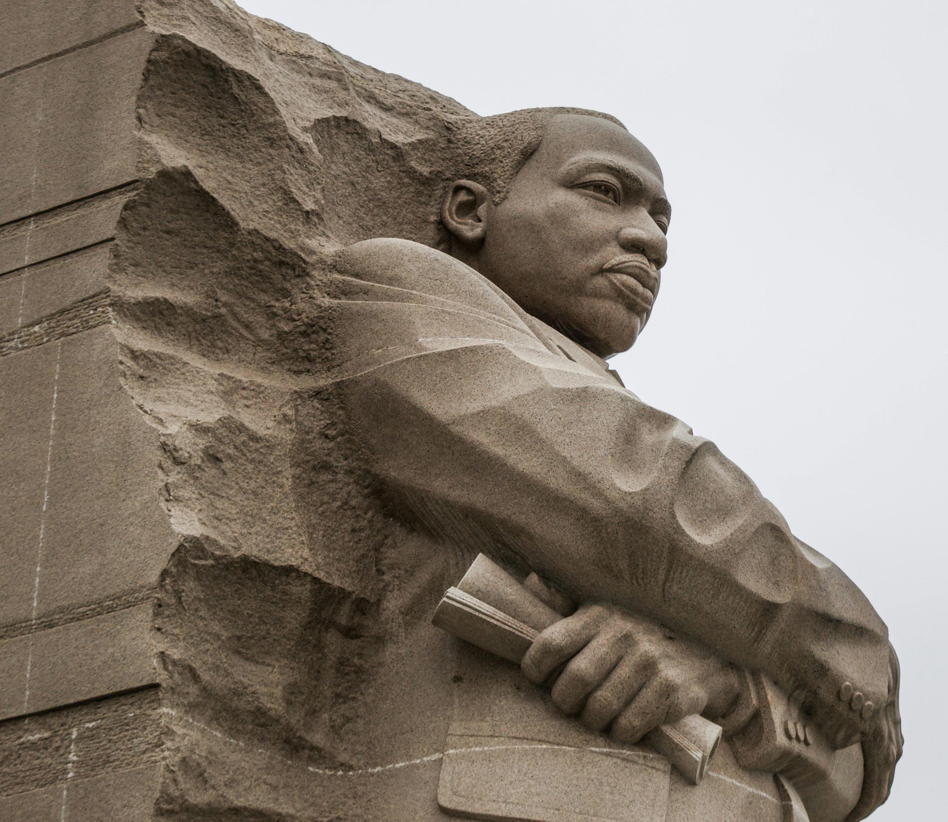 A statue of martin luther king jr. holding a book