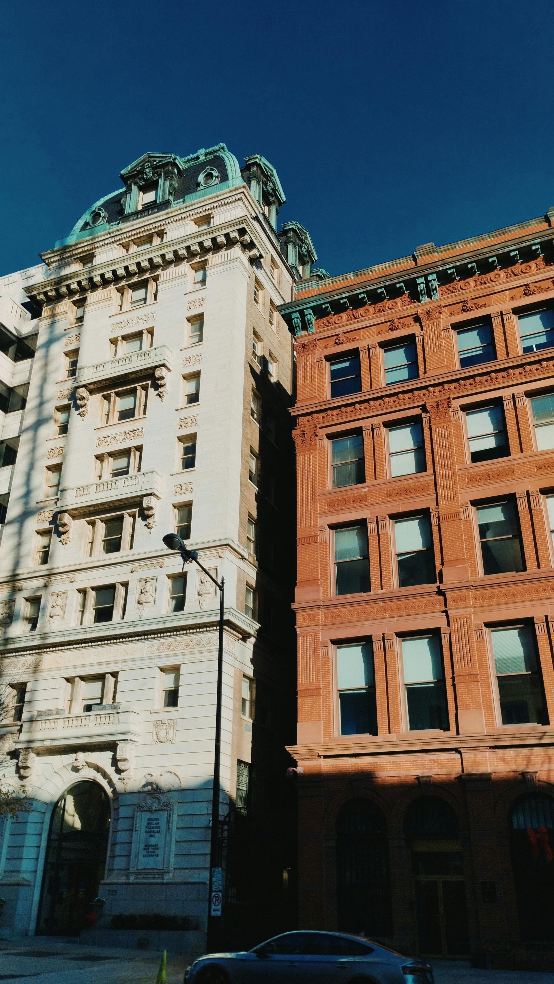 A white building and a red building are next to each other