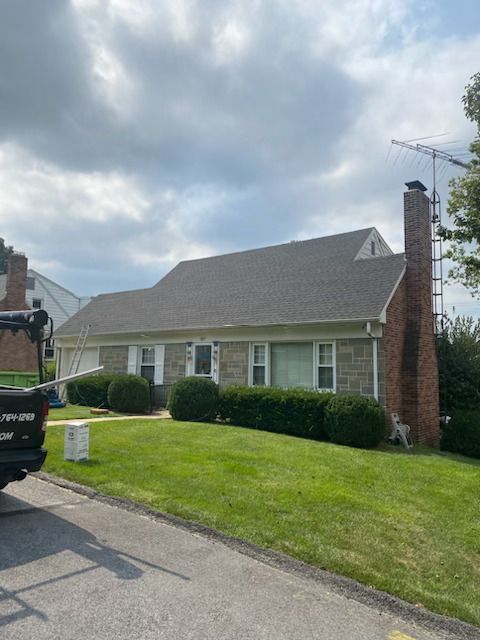 A house with a tractor parked in front of it