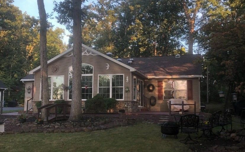 A house with a lot of windows and trees in the background