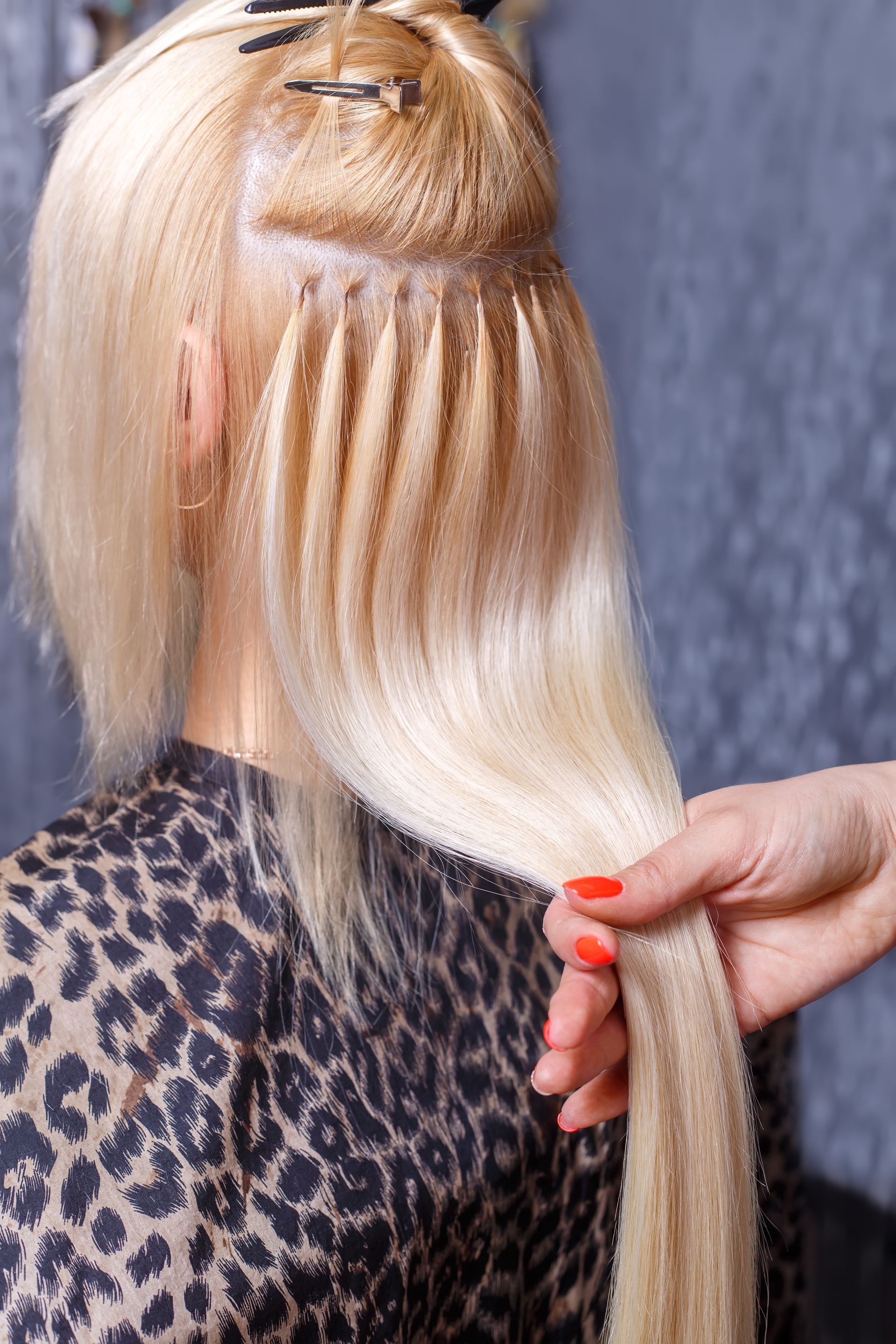 A woman is getting her hair done by a hairdresser.