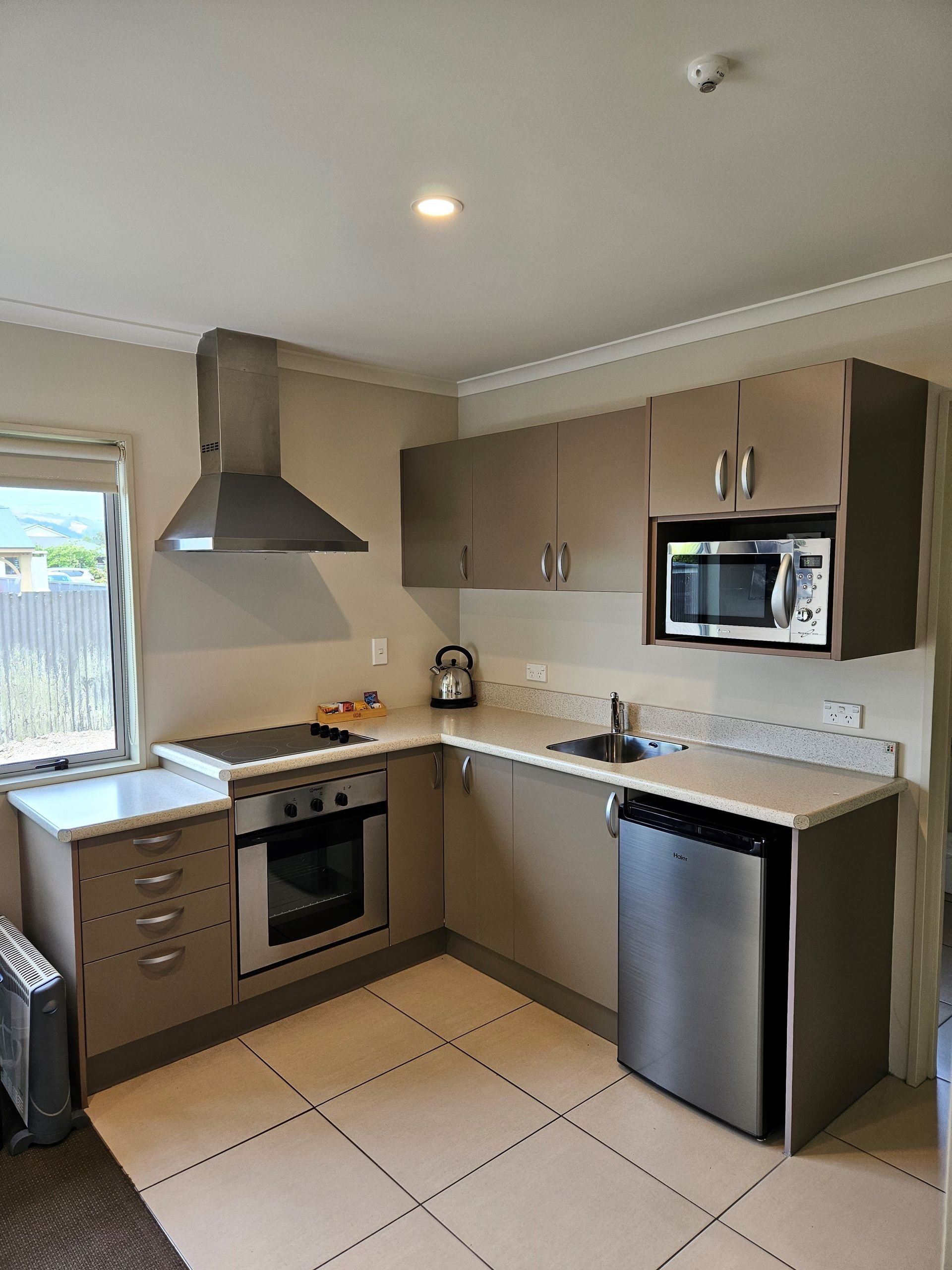 a kitchen with stainless steel appliances and tan cabinets