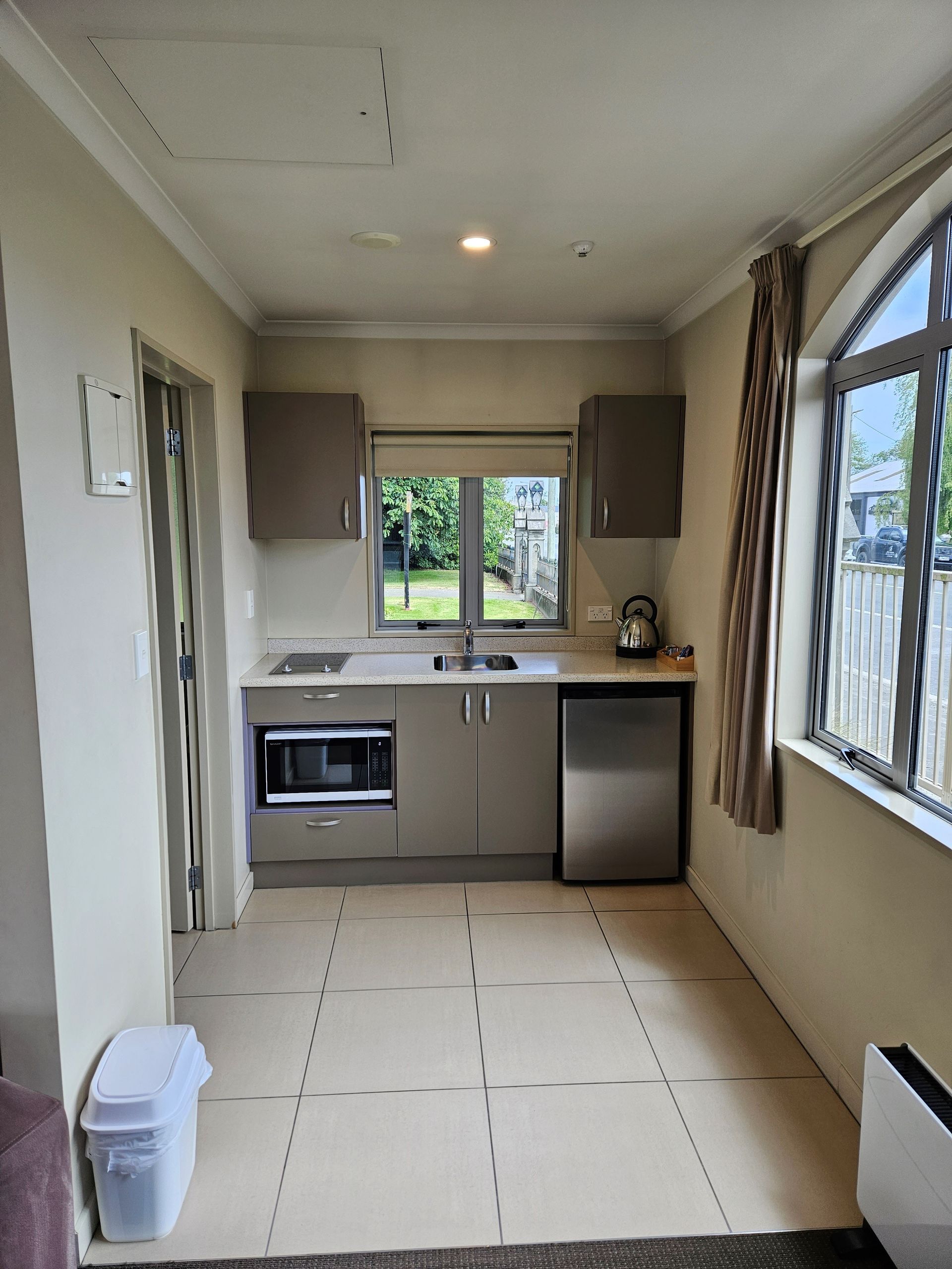 A kitchen with stainless steel appliances and a large window