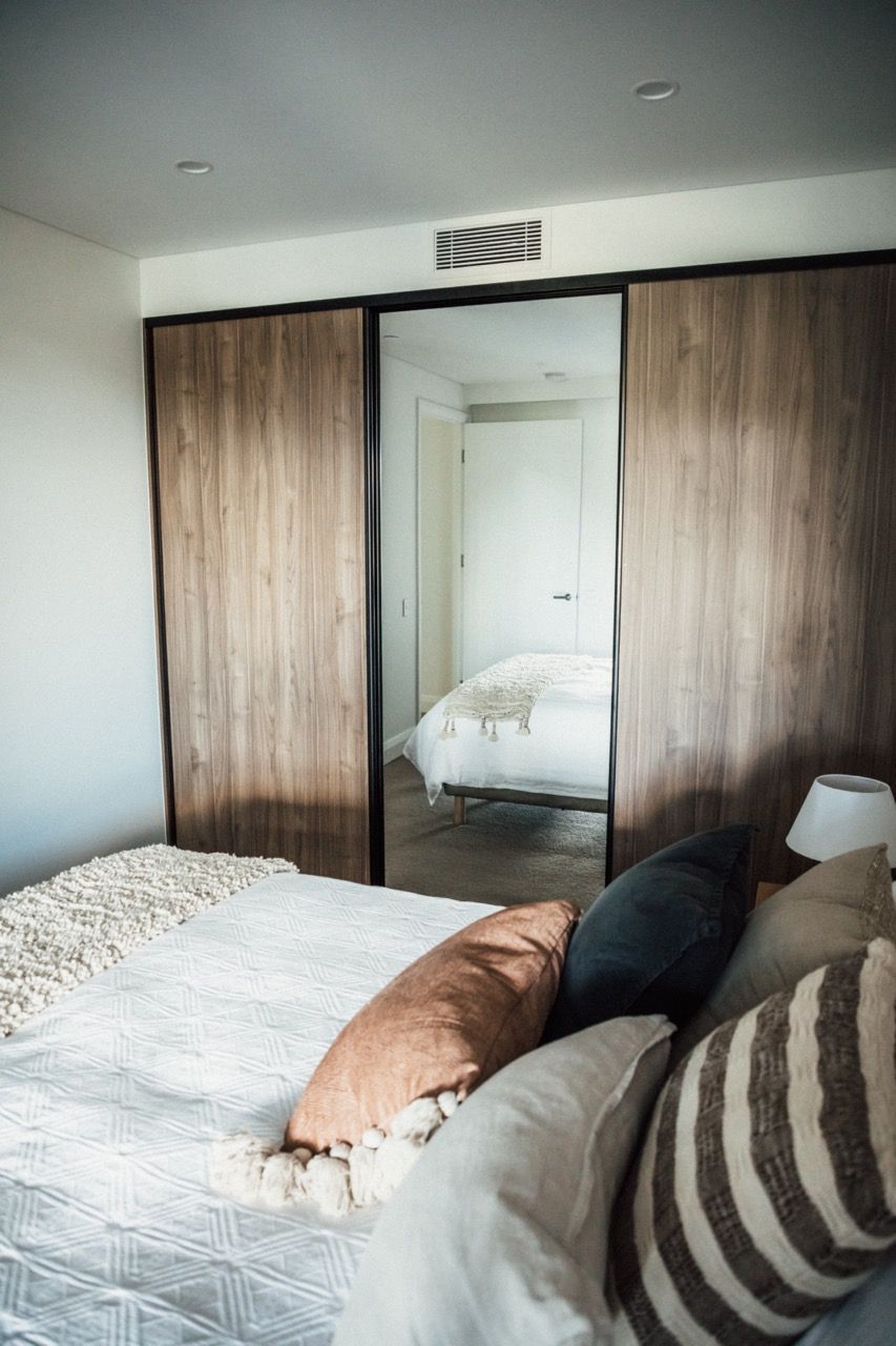 A bedroom with a bed and sliding glass doors