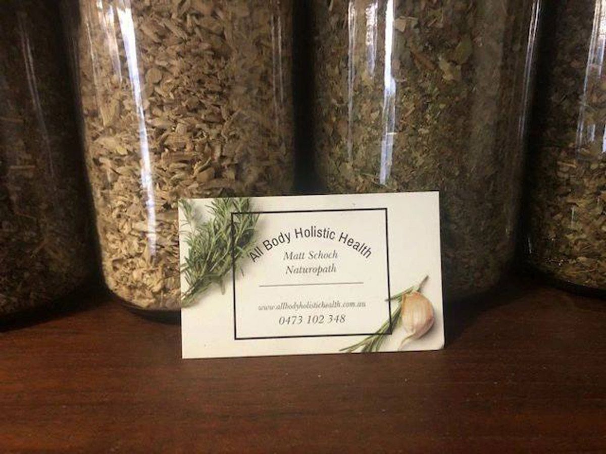 Jars And A Business Card Of A Person Practising Naturopathy On A Table