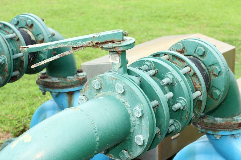 A Close Up of a Green Pipe With a Valve on It — All Systems Wastewater Maintenance In Jilliby, NSW
