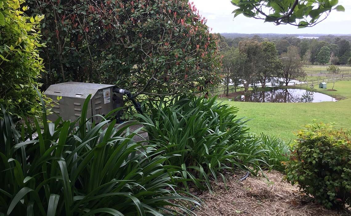 A Lush Green Field With Trees and Bushes Surrounding It — All Systems Wastewater Maintenance In Jilliby, NSW
