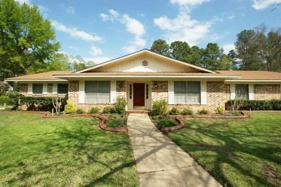 A large brick house with a walkway leading to it