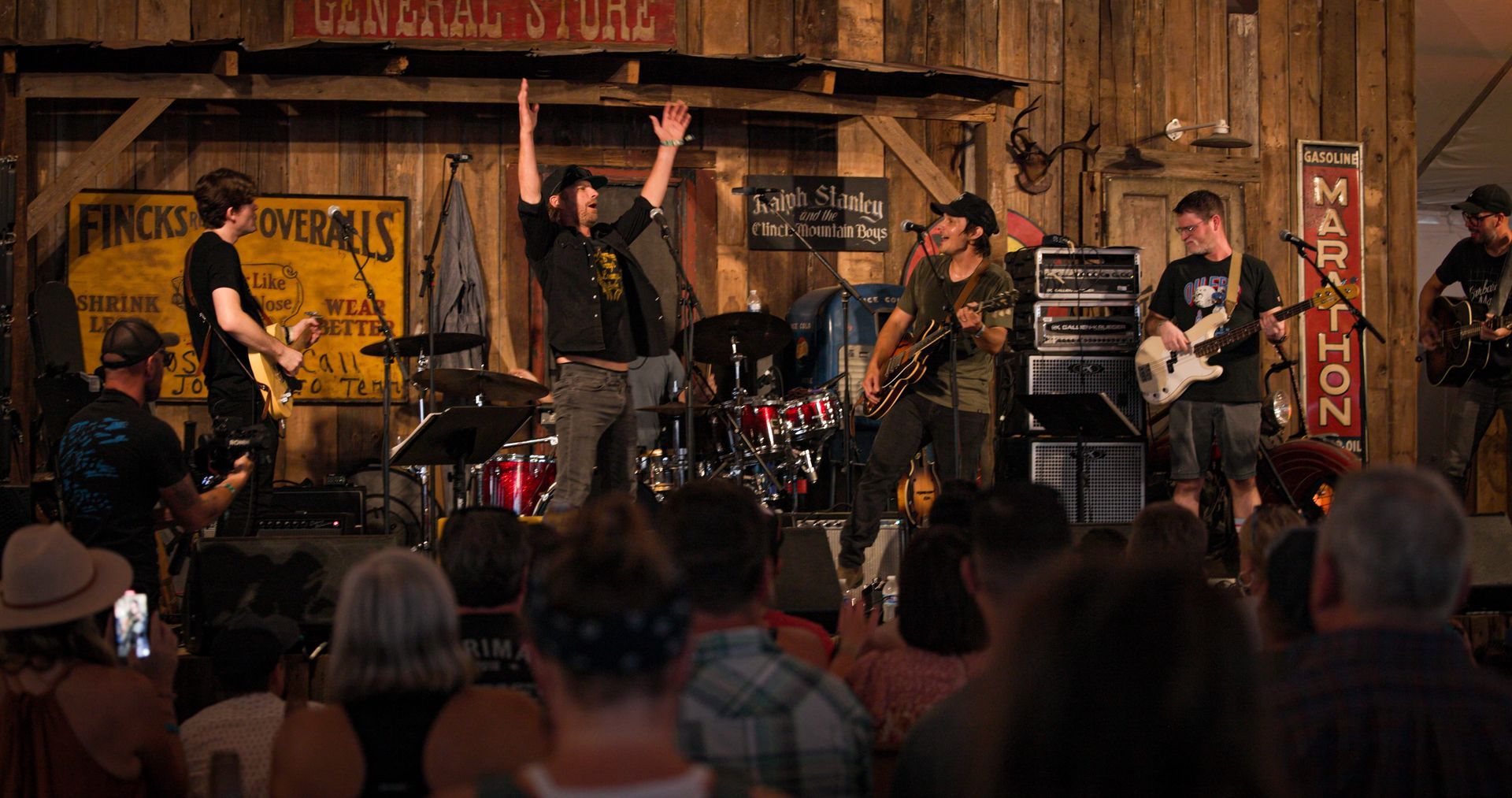 A group of men are playing instruments on a stage in front of a crowd.