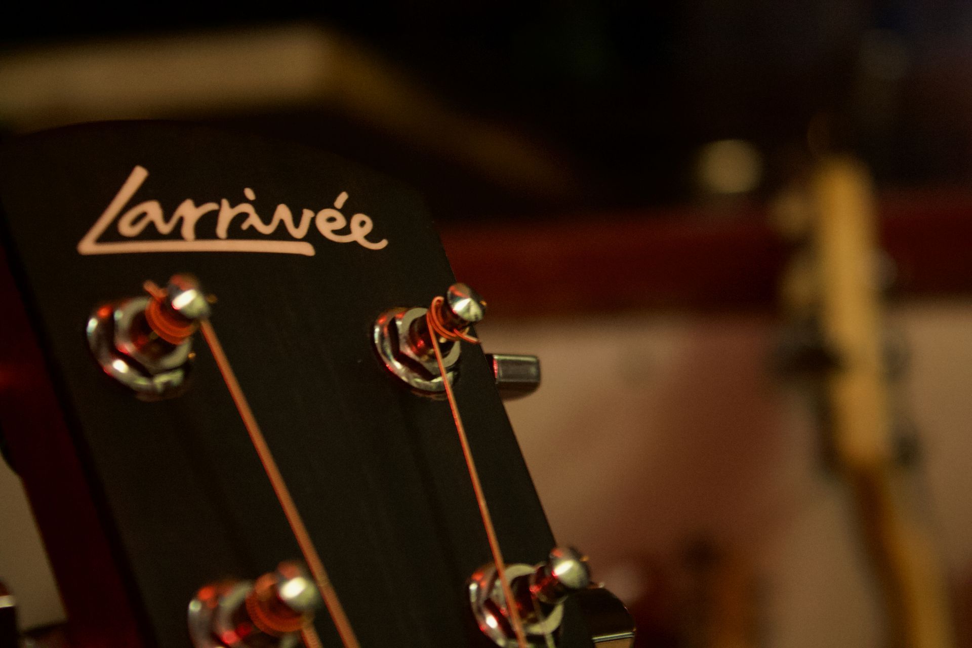 A close up of a larrivée guitar headstock