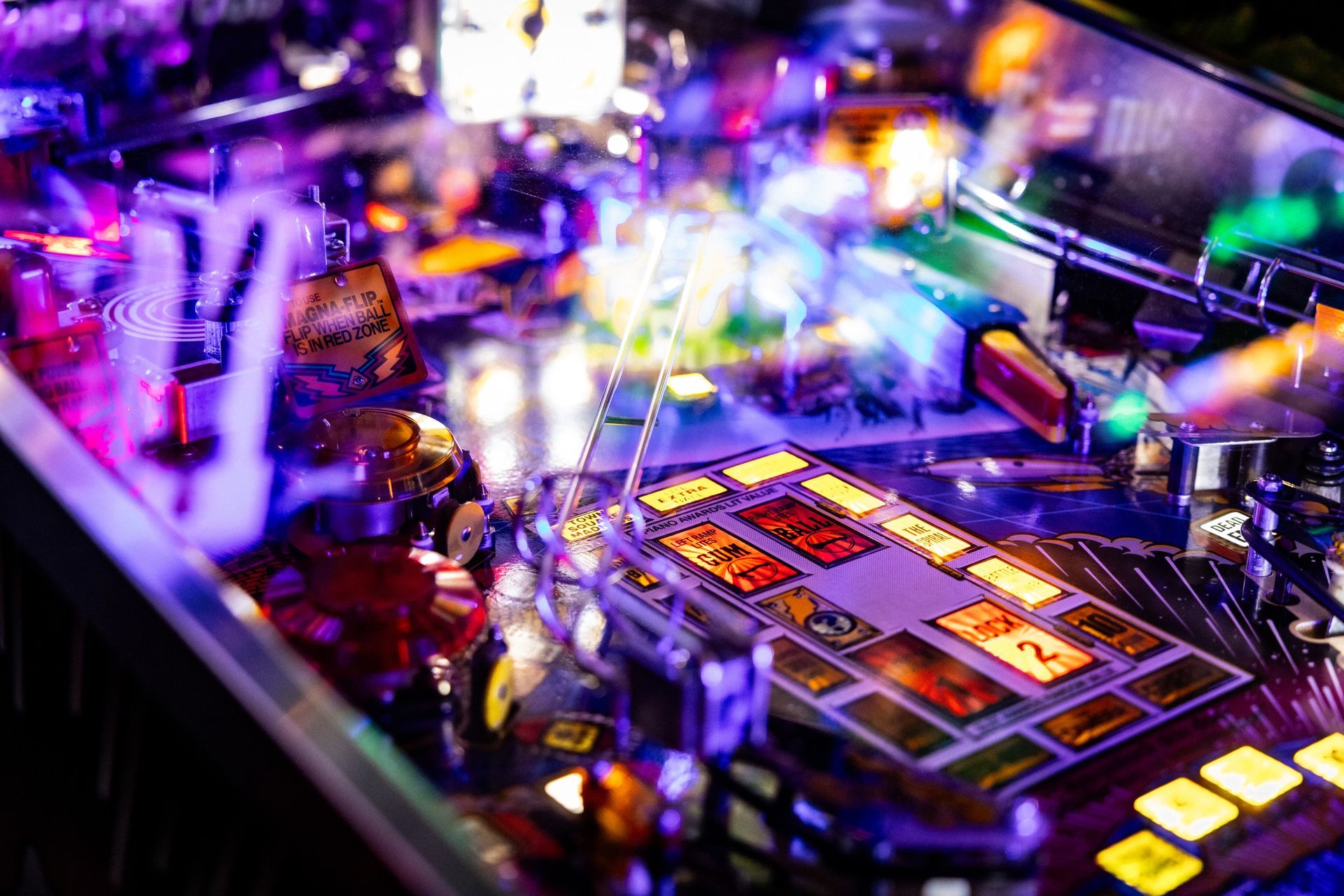 A close up of a pinball machine with a lot of lights on it.