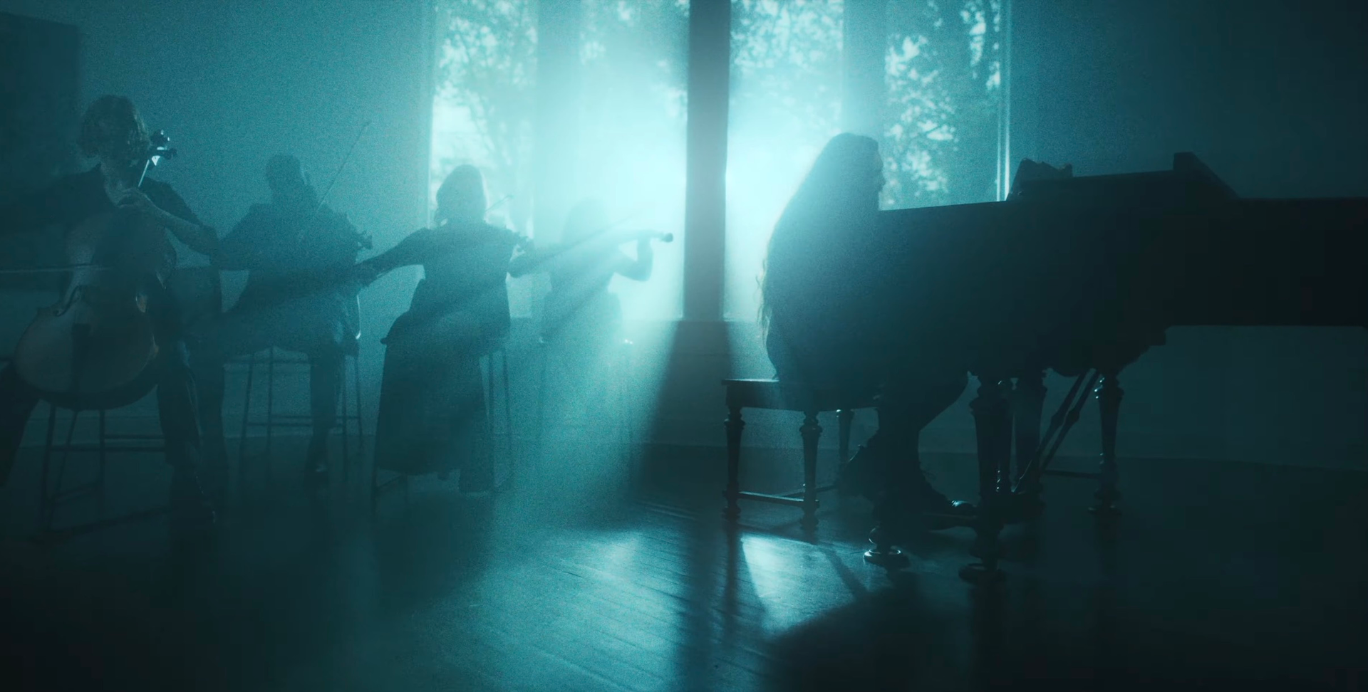 A group of people are playing instruments in a dark room. From Letdown - Crying In The Shower (Reimagined)