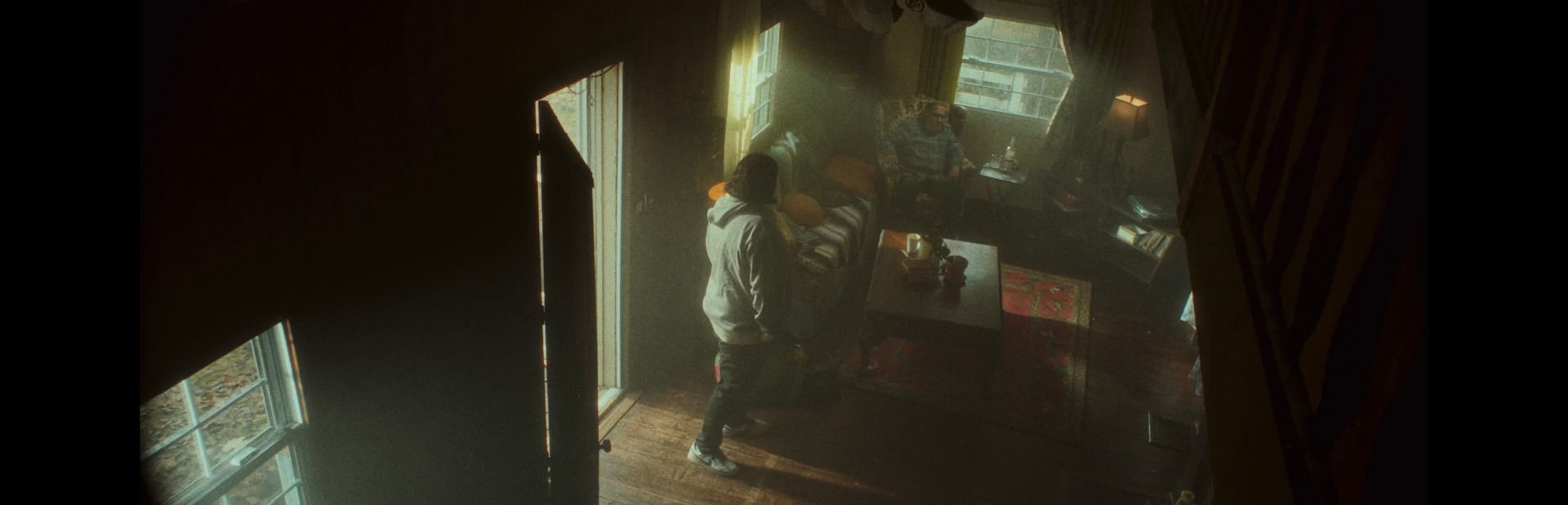 A group of people are standing in a dark room.