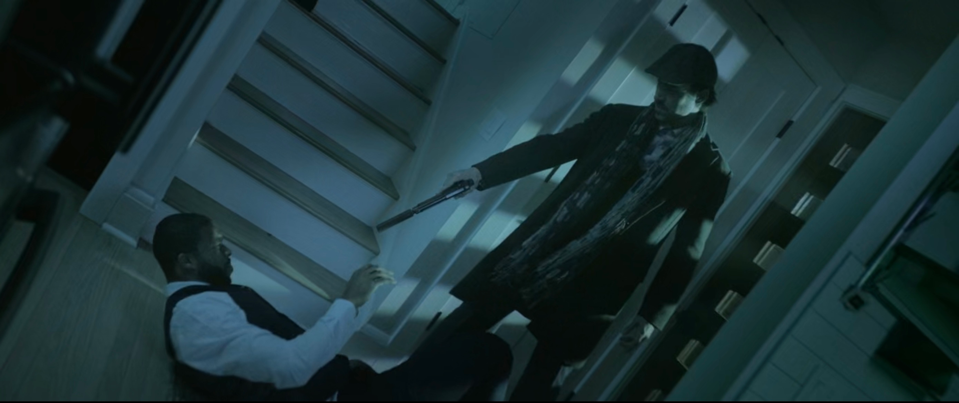 A still from Dark Deceptions. A man is on the ground while another man points a weapon at him.