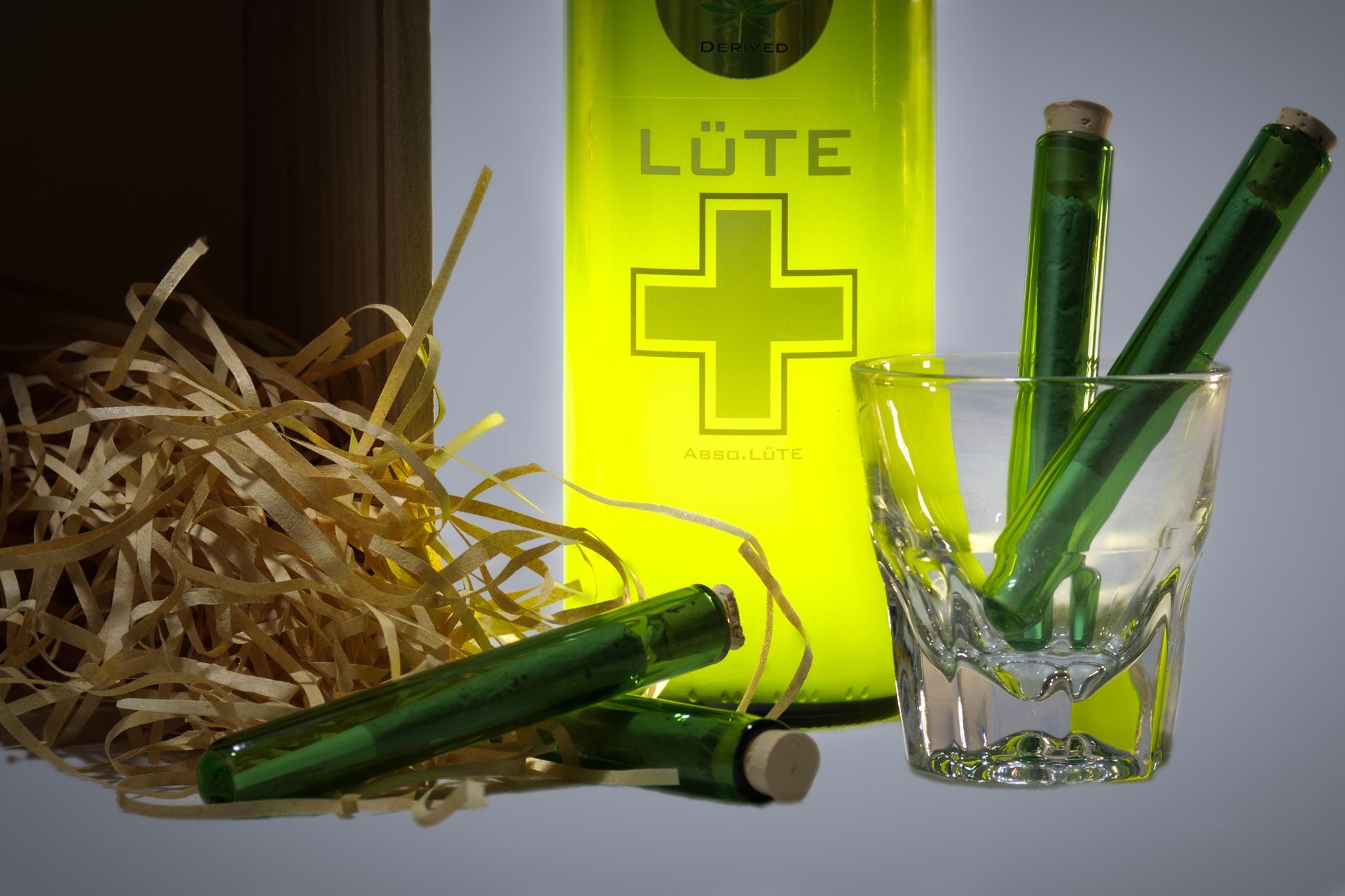 A bottle of lute next to a shot glass
