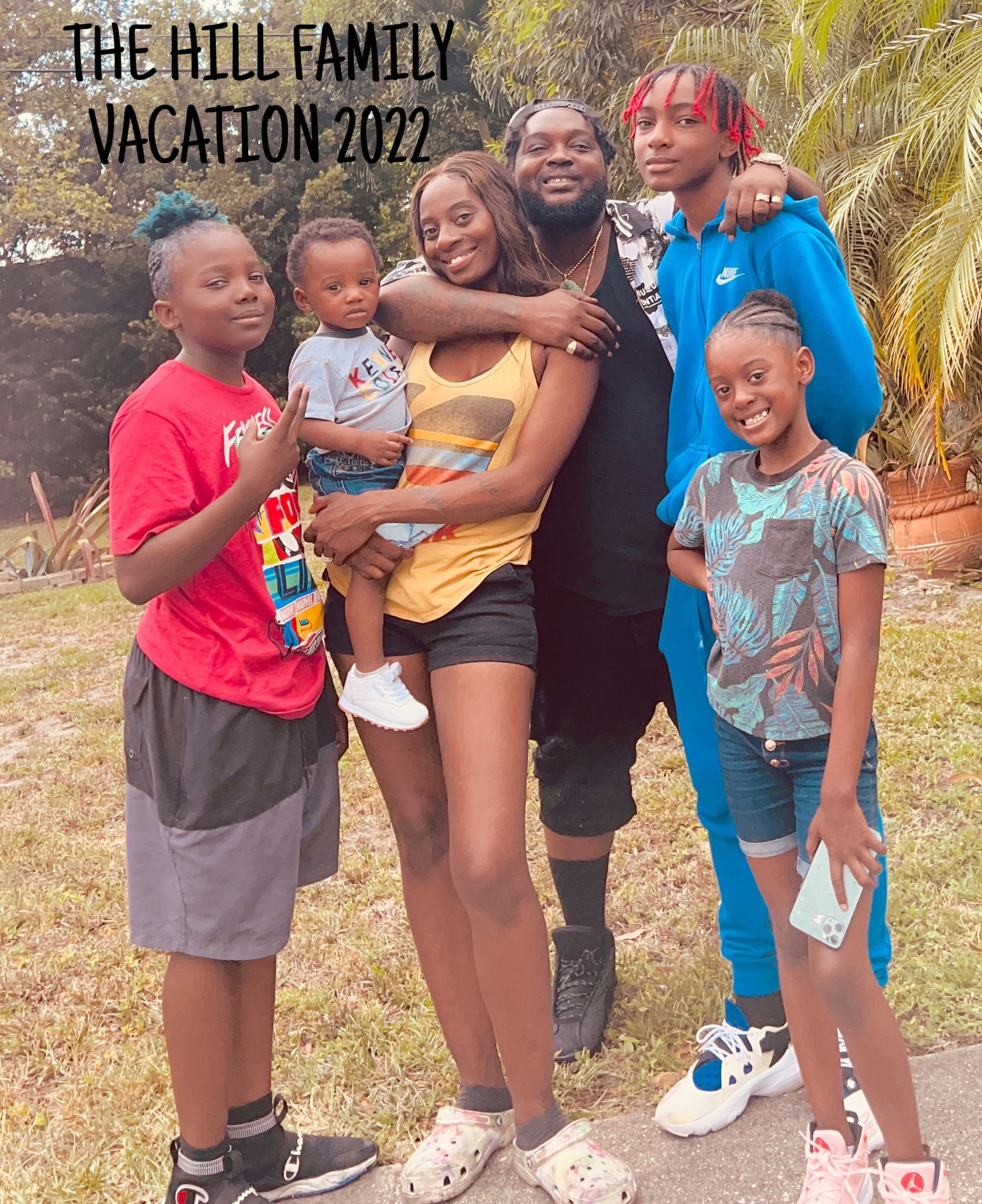 A family is posing for a picture while on vacation in 2022.