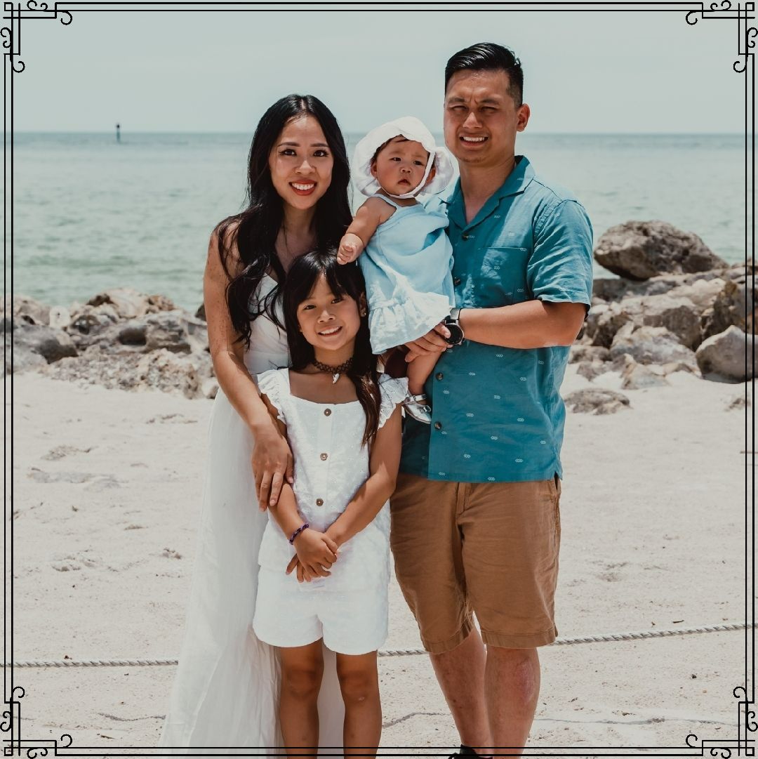 A family poses for a picture on the beach