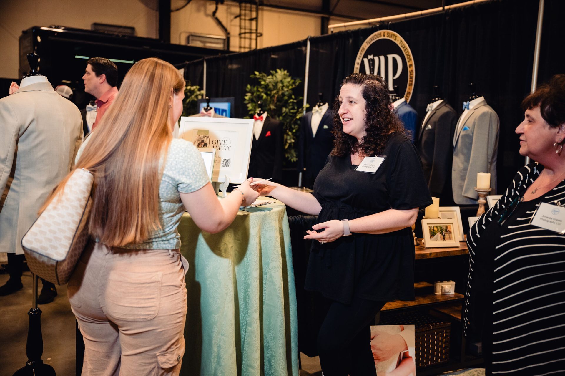 A Vendor at a Bridal Show talks to a potential Bride