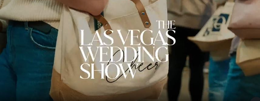 People holding tote bags with “The Las Vegas Wedding Show” printed on them.