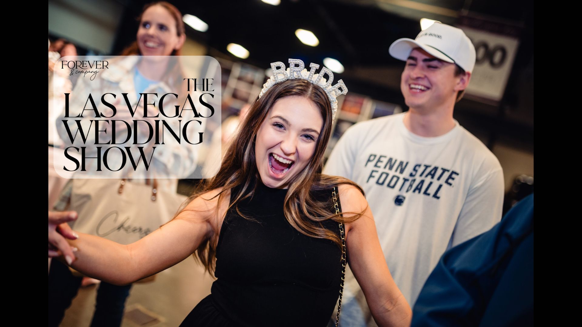 Woman wearing tiara, smiling, at the Las Vegas Wedding Show, with others in background.