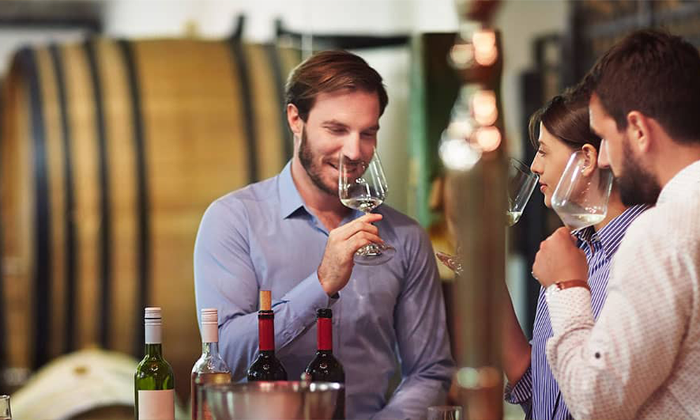 2 men and 1 women wine tasting & smelling glasses of wine on Cable Car Wine Tours