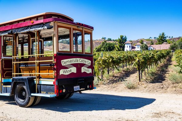 Trolley from Cable Car Wine Tours parked at vineyard in Temecula CA