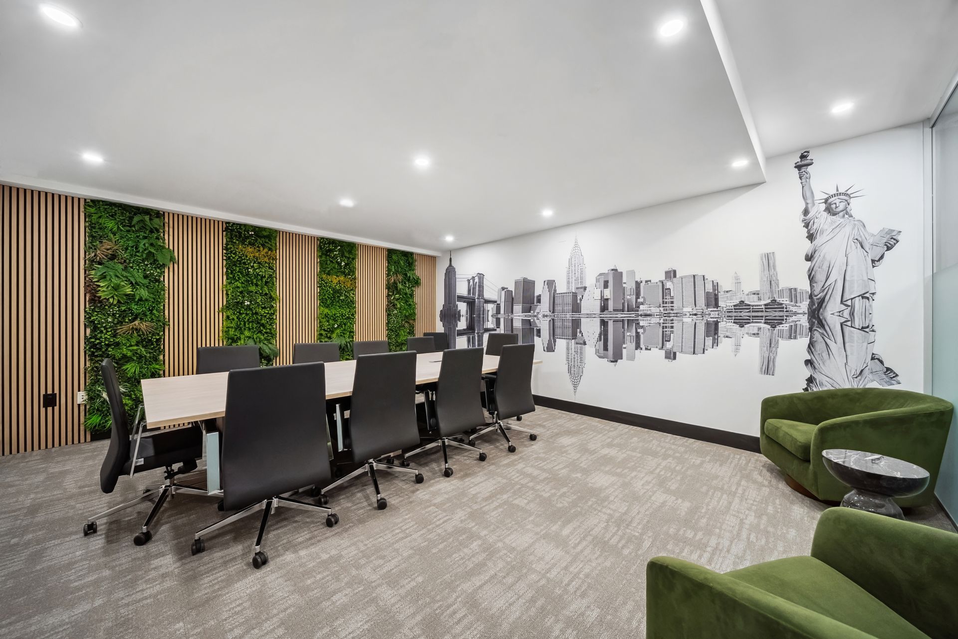 A conference room with a long table and chairs and a statue of liberty on the wall.