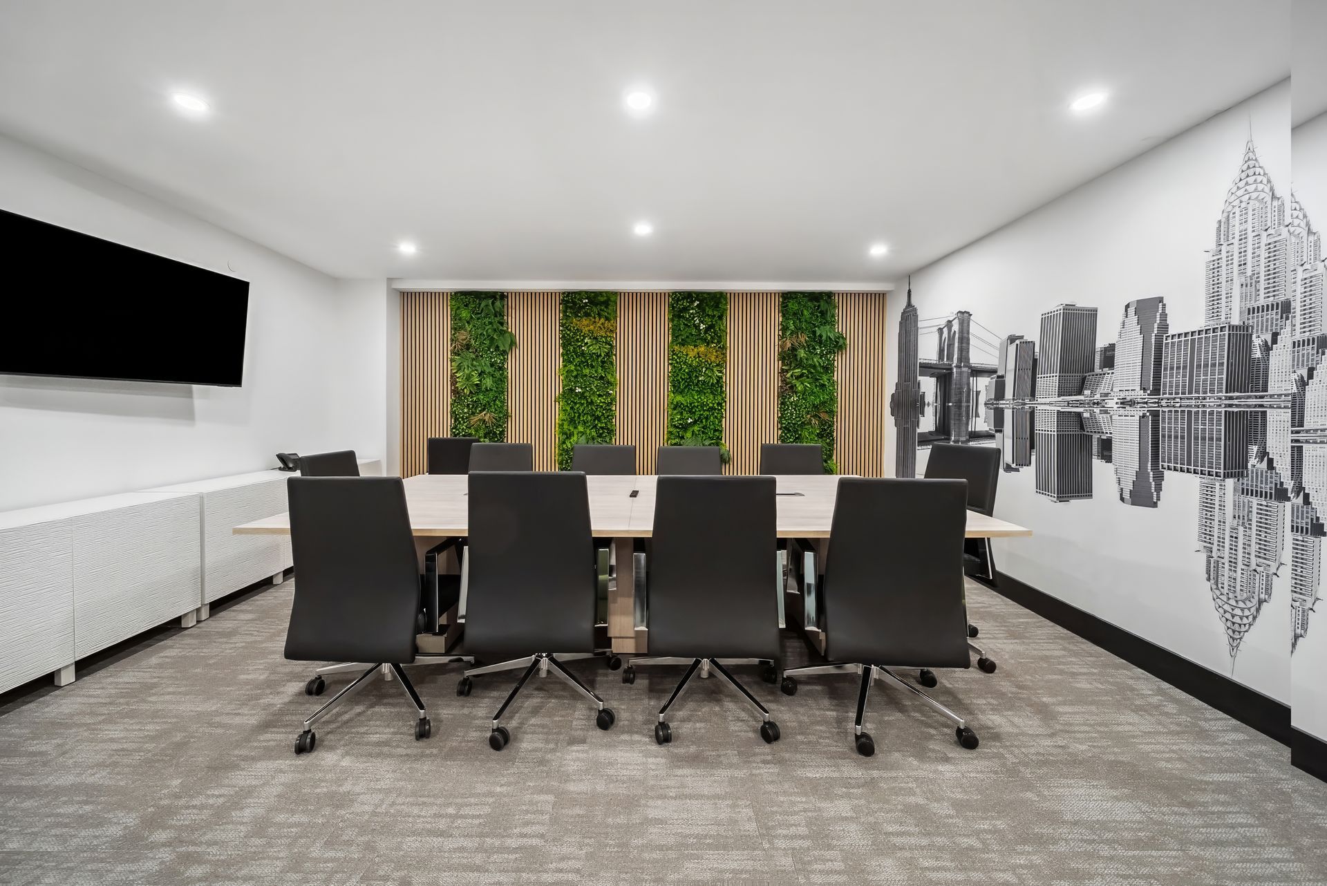 A conference room with a long table and chairs.