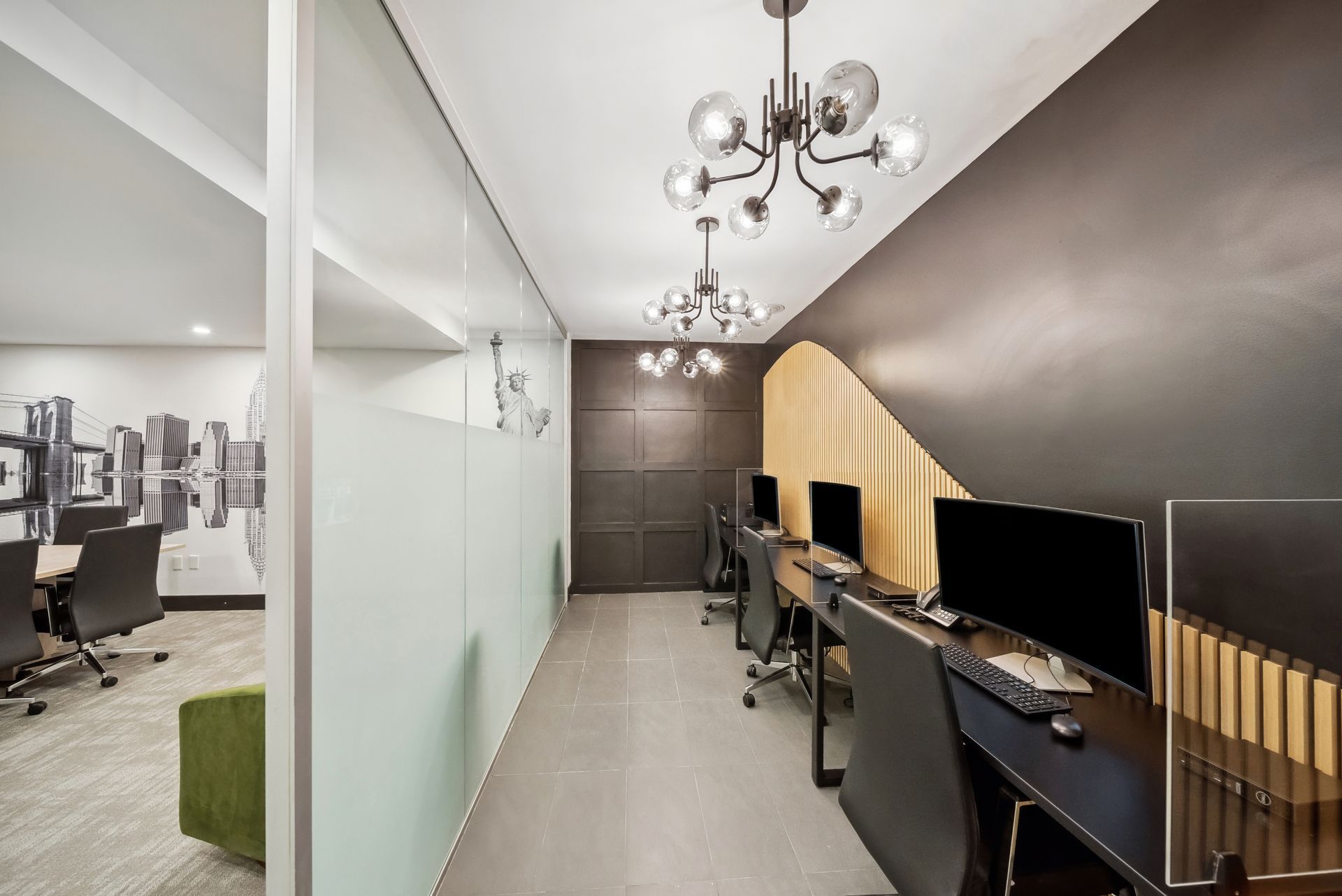 A room with a lot of computers and chairs in it