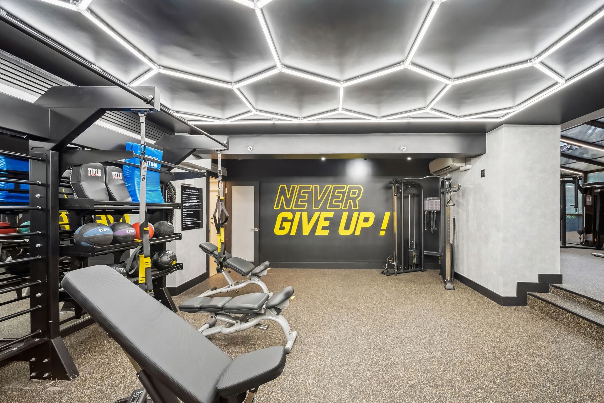 A gym with a sign that says `` never give up '' on the wall.
