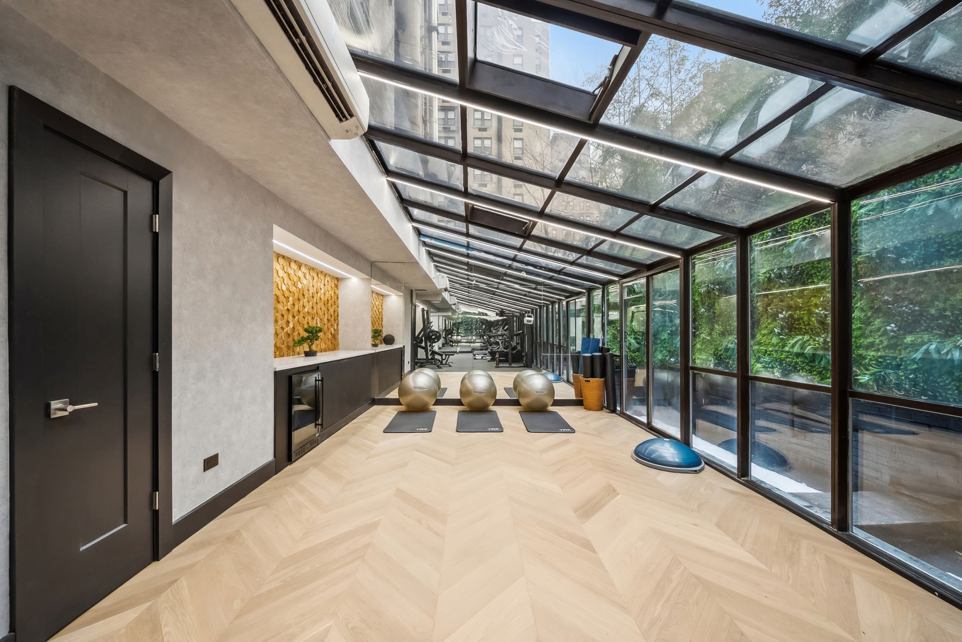 A large room with a lot of windows and wooden floors.