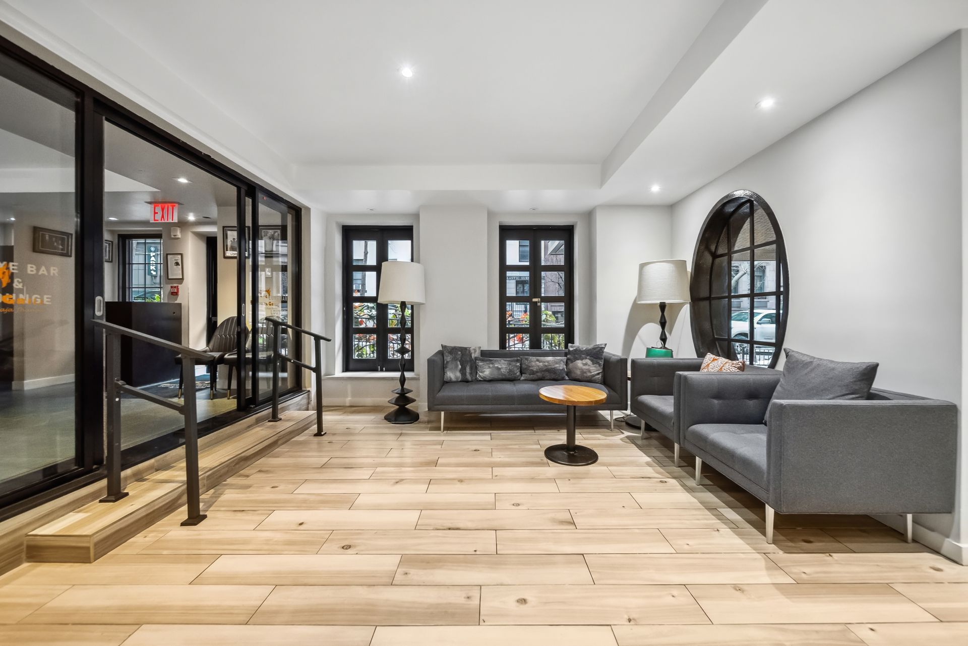 A living room with a couch , chairs , and a table.