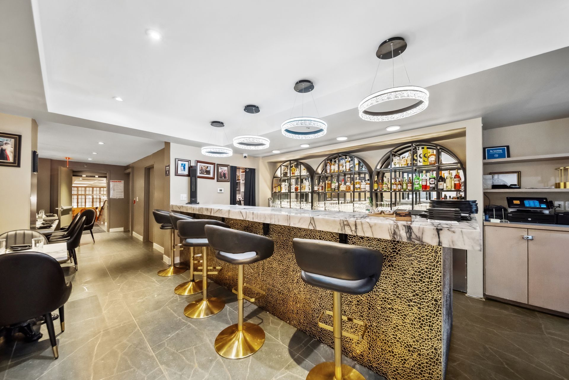 A restaurant with a long bar and stools.