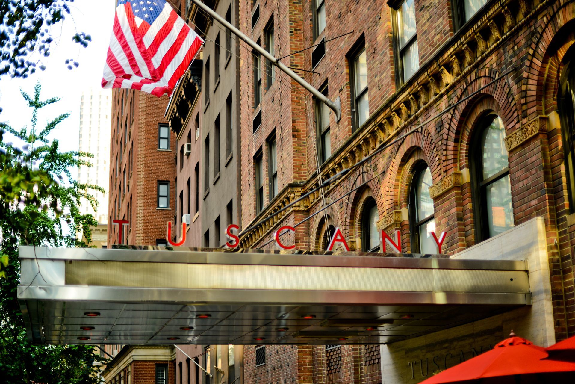 A large brick building with the word tuscany on it