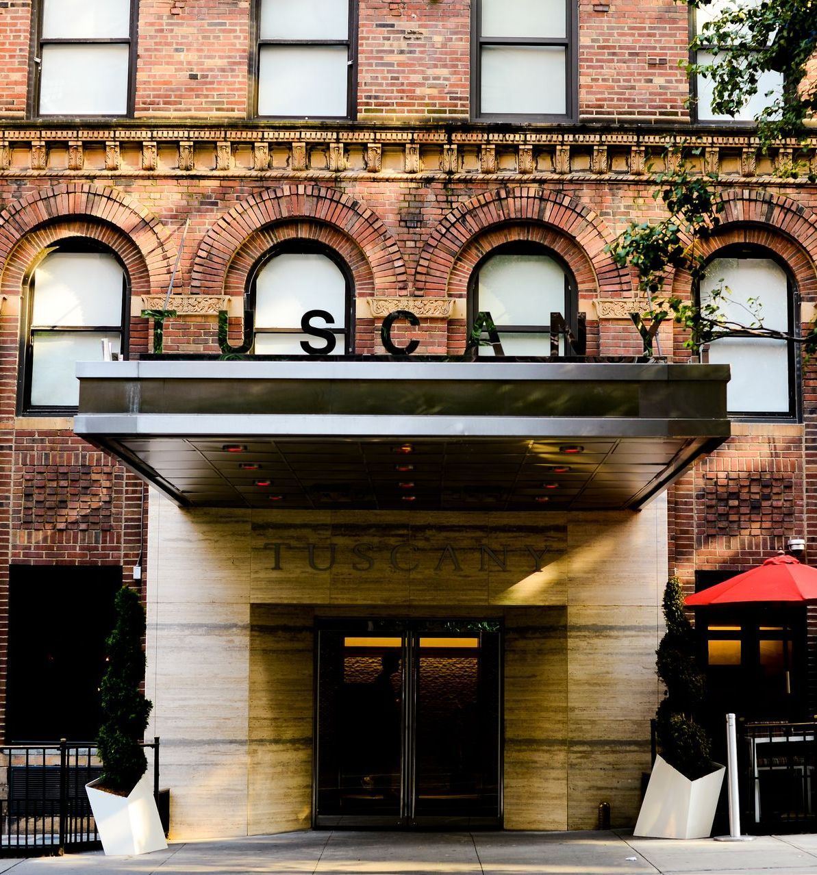 A brick building with the word tuscany on it