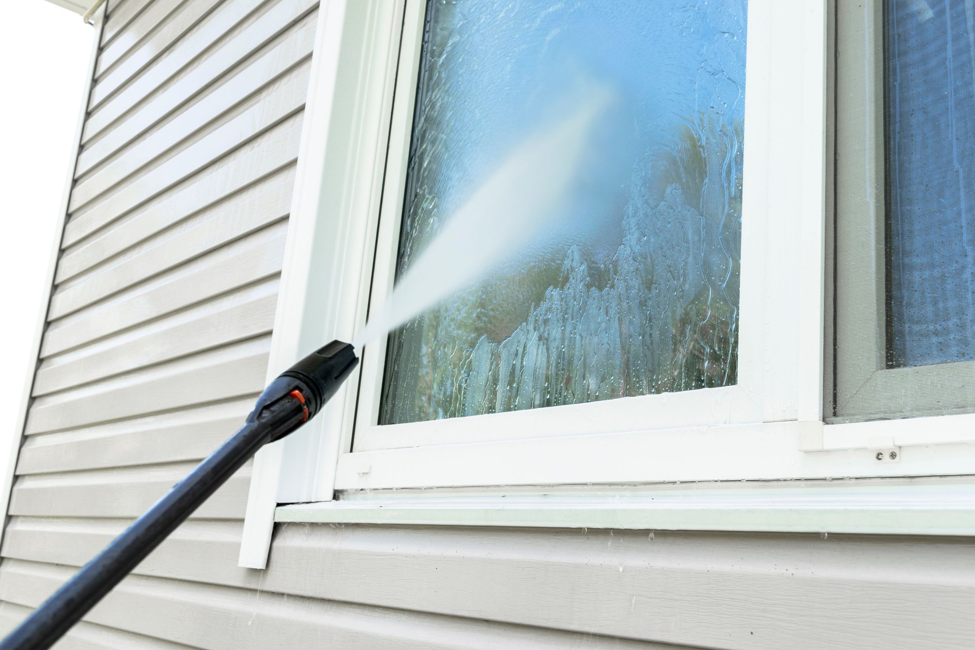 cleaning window with power washer