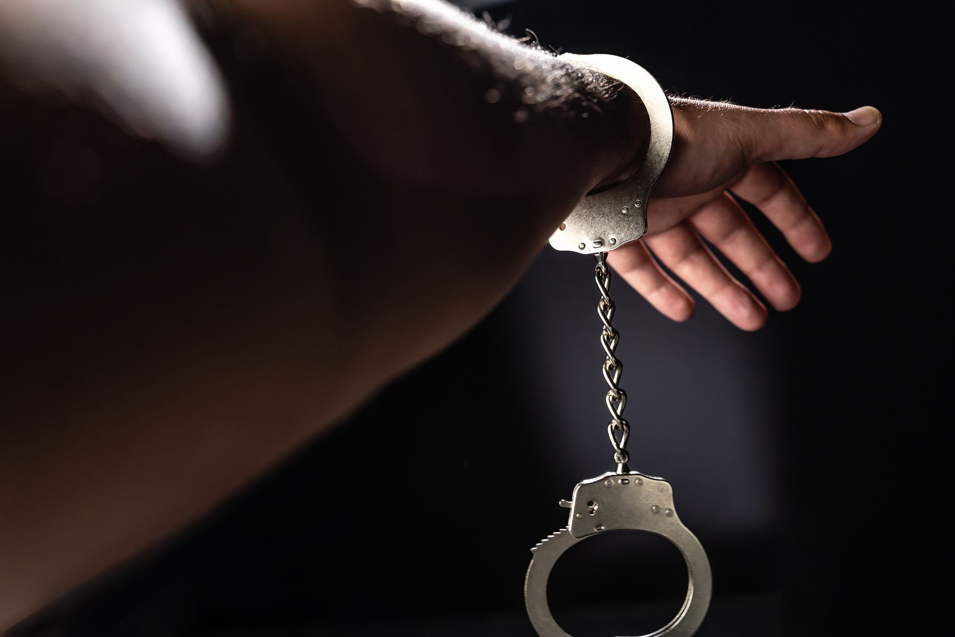 A close up of a person 's hand with handcuffs