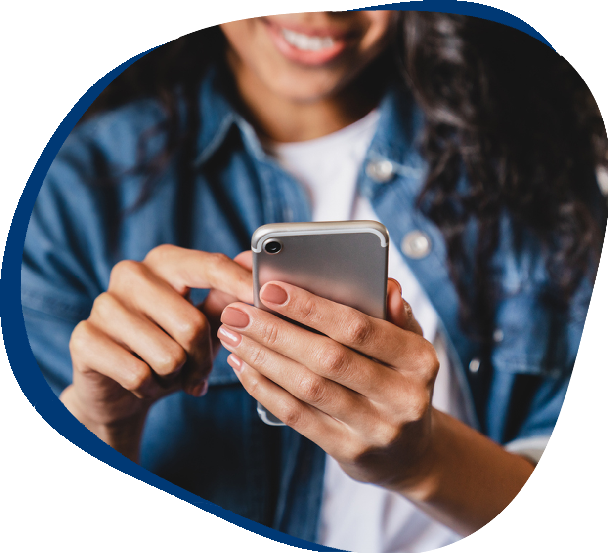 Smiling woman using smartphone at home