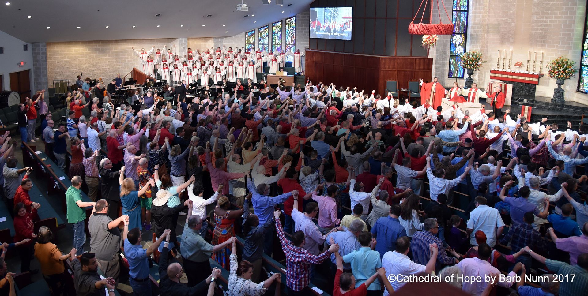 Congregation with hands raised.