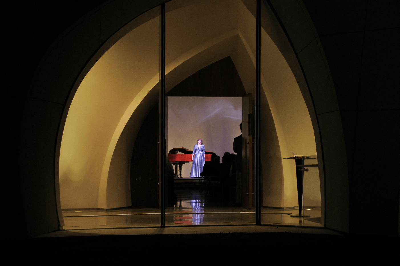 Interfaith Peace Chapel viewed through a window.  Concert in progress.