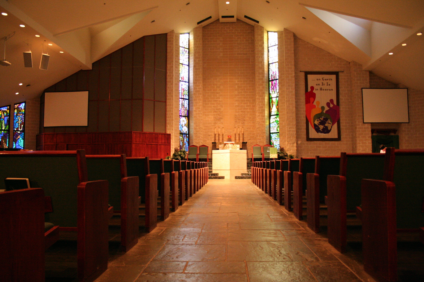 Main sanctuary with daylight streaming through the stained glass windows.