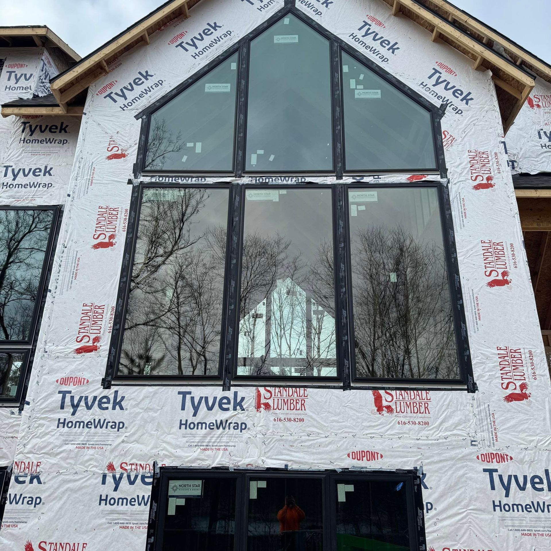 A building under construction with tyvek homewrap on the side
